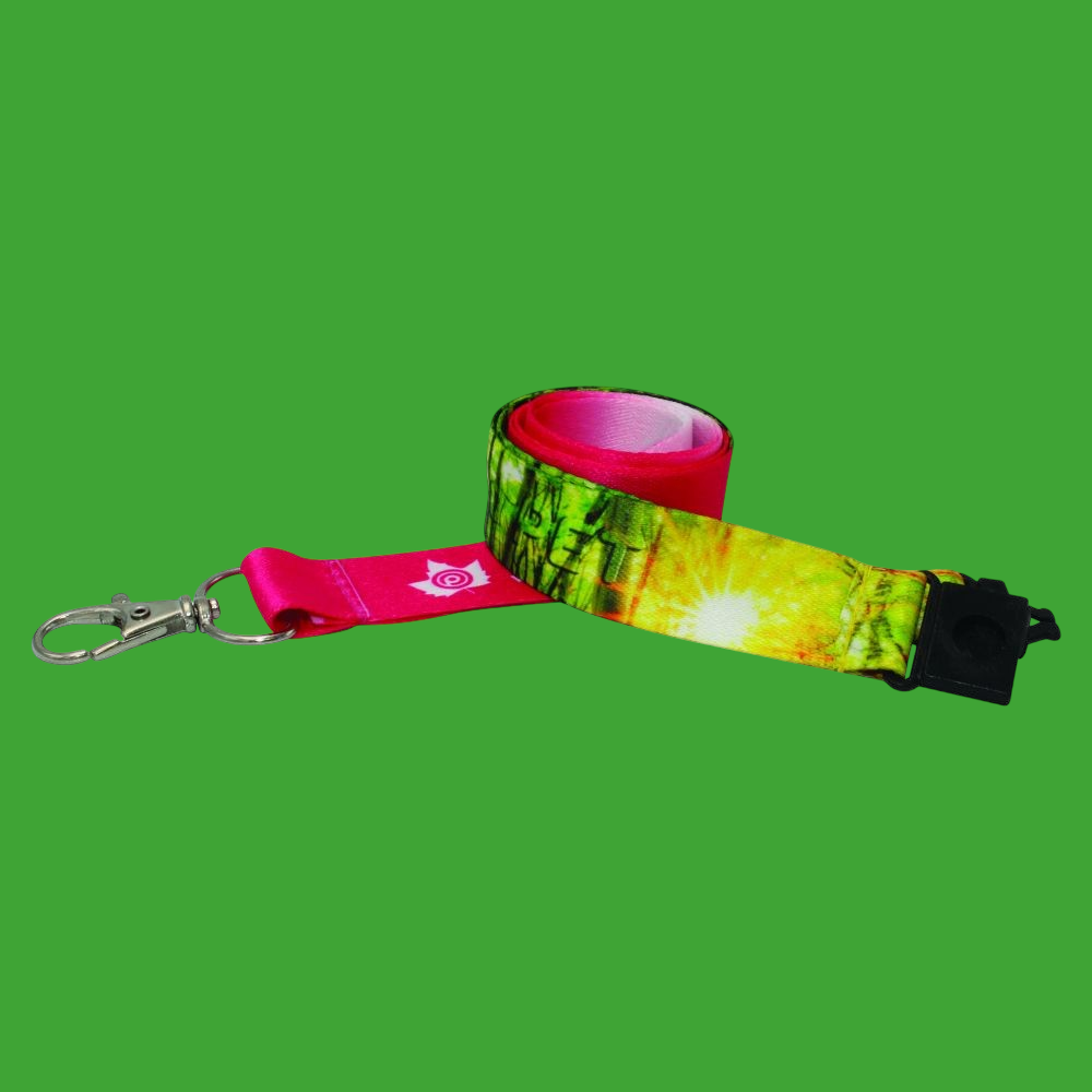 A rolled up lanyard with a bright forest design on red